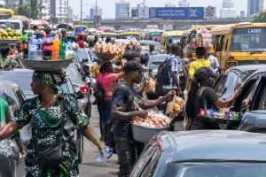 Hawkers take advantage of daily traffic experience in Lagos to make ends meet. They hawk snacks ,water , beverages and others